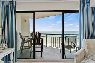 Balcony with view of water and beach