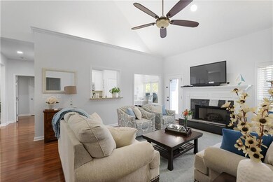 Living area with a premium fireplace, high vaulted