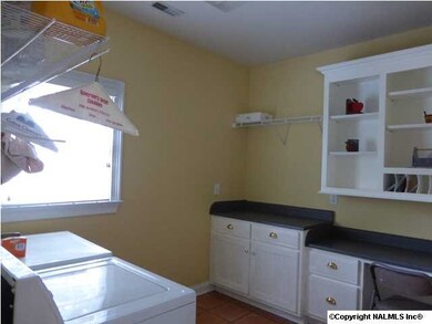 The 11'x9' Laundry room has built in desk and cabinets.
