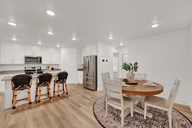 Dining room with light wood-type flooring and recessed lighting