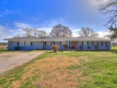 Single story home featuring dirt driveway, fence, 