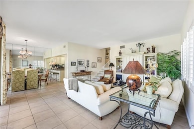 Tiled living room with a chandelier
