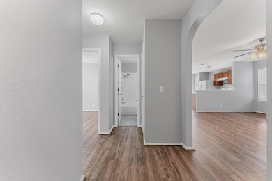 Hallway with wood finished floors and arched walk