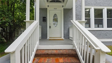 Property entrance with stucco siding and covered p