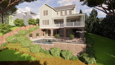 Rear view of property featuring a balcony and brick siding