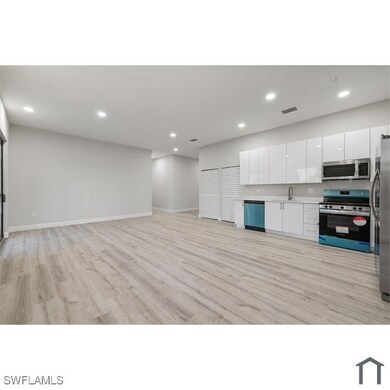 Kitchen featuring light wood finished floors, whit
