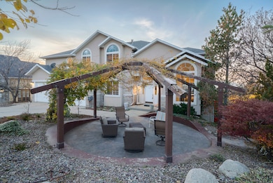 View of front of property with a patio and stucco siding