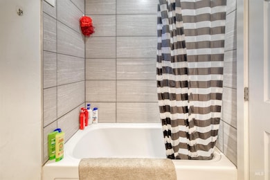 Full bathroom with shower / bath combination with curtain
