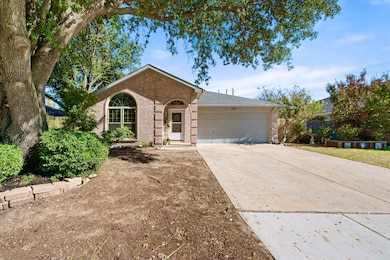 Ranch-style house with concrete driveway, brick siding, and an attached garage