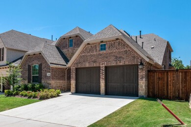 View of front of house with a garage and a front lawn