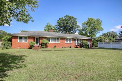 Ranch-style house with crawl space, brick siding, a chimney, and entry steps