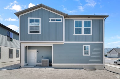 Rear view of property with board and batten siding