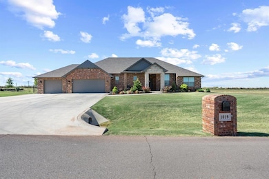 View of front of house with brick siding, driveway