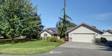 View of home also shows the matching detached garage.