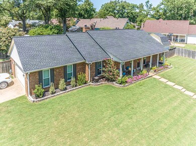 View of front of house with a front yard and a gar