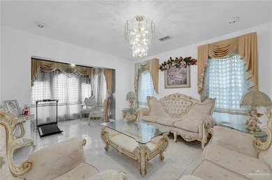 Tiled living area featuring a chandelier