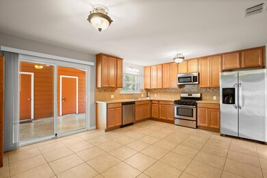 Large kitchen, stainless steel appliances, and neutral cabinetry make cooking a breeze