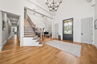 Entryway featuring ornamental molding, light hardw