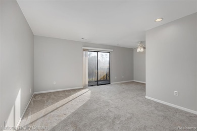 Empty room with recessed lighting, light colored carpet, and a ceiling fan
