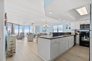 Kitchen with black appliances, white cabinets, exp