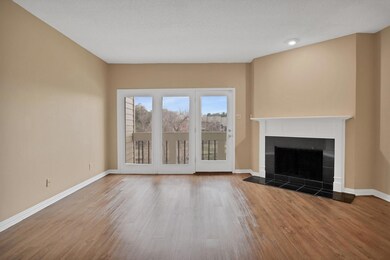 Unfurnished living room featuring a textured ceili