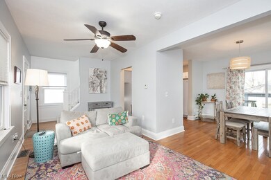 Living room with ceiling fan and light hardwood / wood-style floors