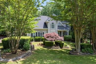 View of front of property with roof with shingles, a front lawn, and stucco siding
