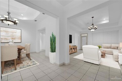 Dining room with light tile patterned flooring, a raised ceiling, visible vents, and a notable chandelier