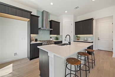 Kitchen featuring a sink, a kitchen bar, stove, w