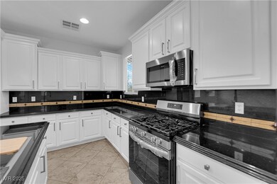Kitchen featuring appliances with stainless steel