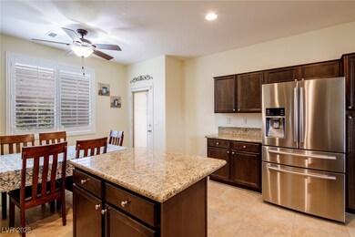 Kitchen with stainless steel fridge, a ceiling fan