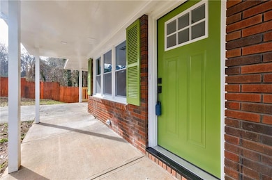 View of exterior entry with a porch