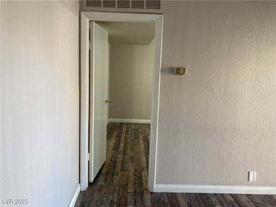 Hallway featuring dark hardwood / wood-style floor