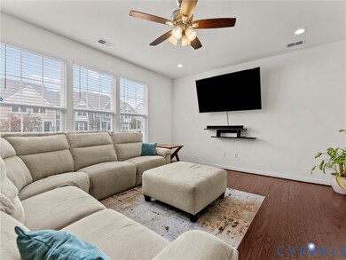 Living room featuring wood finished floors, a ceiling fan, and recessed lighting