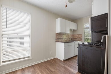Kitchen with a textured ceiling, range with gas s