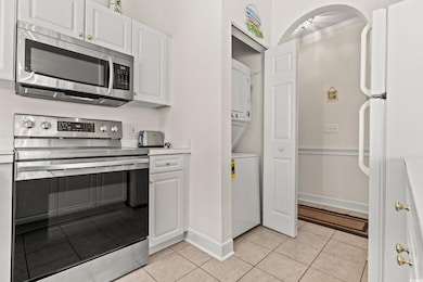 Kitchen with light tile patterned floors, stacked 