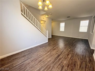 Unfurnished living room featuring dark wood finish