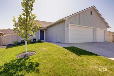 Ranch-style house featuring concrete driveway and an attached garage