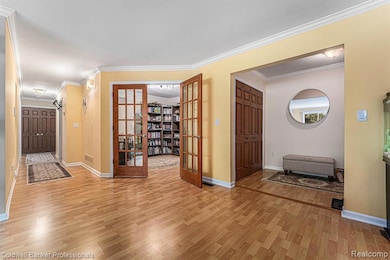View of the foyer opening into Living Room and the French doors of Library/office