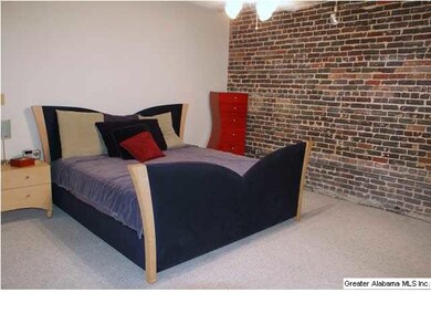 Bedroom one with exposed brick walls