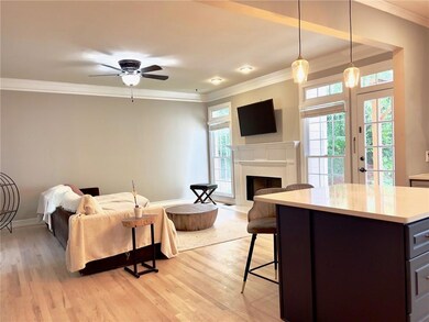 Living room featuring ornamental molding, light wo