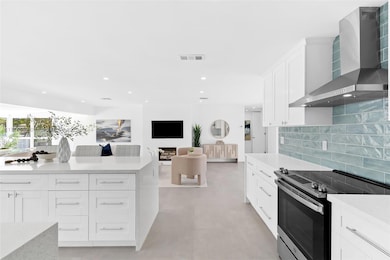 View from kitchen to living room and hallway to bedrooms