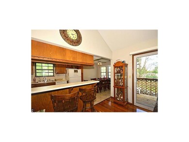 Large  each in kitchen with eating bar area...walks out to private deck.