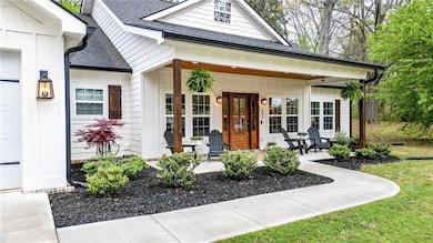 View of front of house with covered porch and a sh