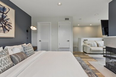 Bedroom featuring wood finished floors, visible v