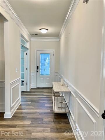 Extended entry with LVP flooring and moldings