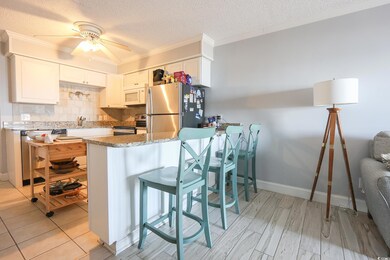 Kitchen featuring crown molding, stainless steel a