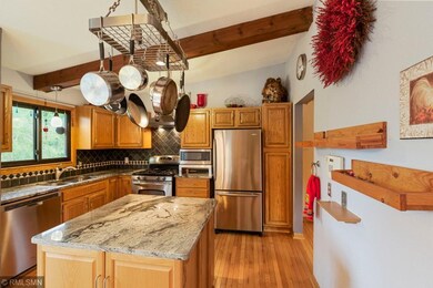 The kitchen boasts a center island, granite counte