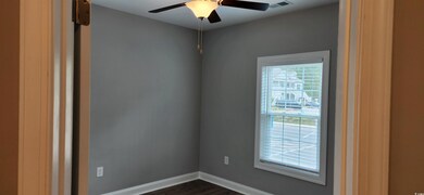 Empty room with ceiling fan and dark hardwood / wo