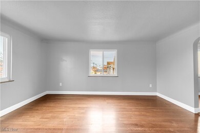 Unfurnished room with wood-type flooring and a textured ceiling